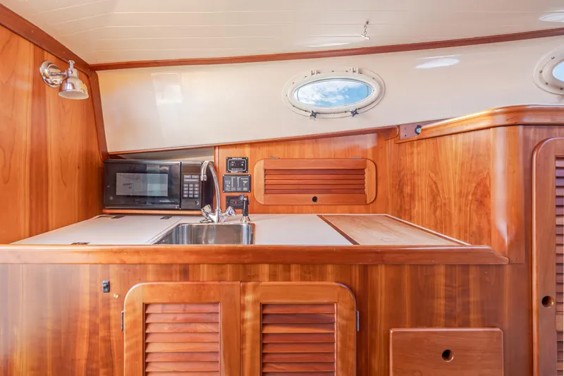 Slide: The Image of Interior of 2001 Hinckley Picnic Boat 36 Classic with wooden cabinetry and modern amenities. - 28