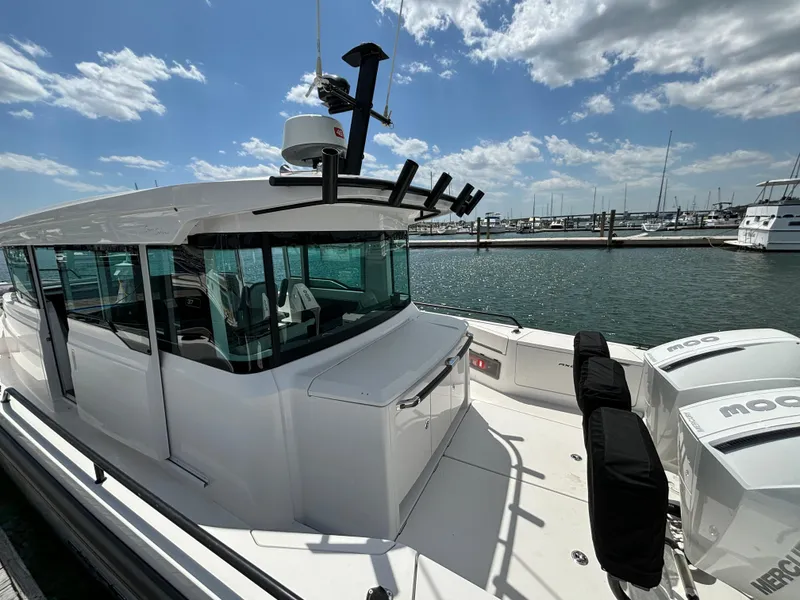 Slide: The Image of 2020 Axopar 37 XC boat docked at a marina on a sunny day. - 35