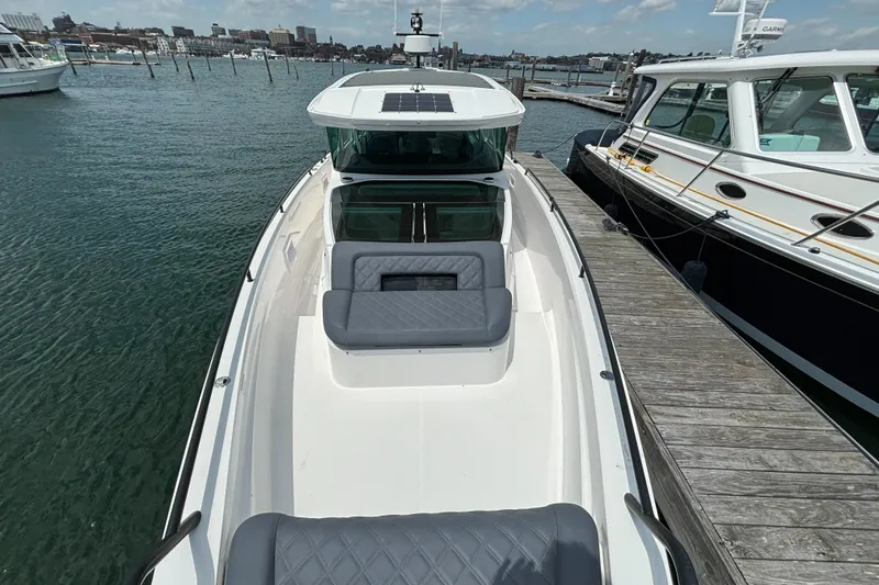 Slide: The Image of 2020 Axopar 37 XC boat docked at marina, front view. - 38