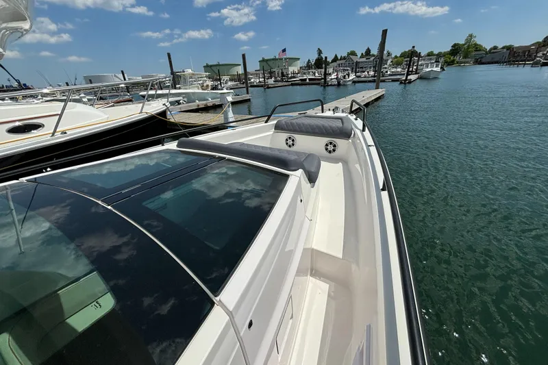 Slide: The Image of 2020 Axopar 37 XC boat docked at a marina on a sunny day. - 37