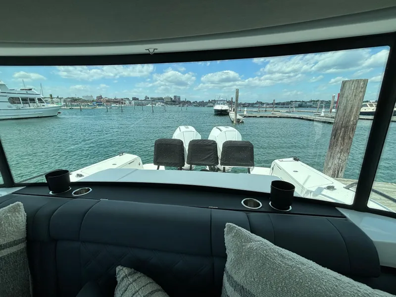 Slide: The Image of View from the interior of a 2020 Axopar 37 XC boat, overlooking a marina. - 16
