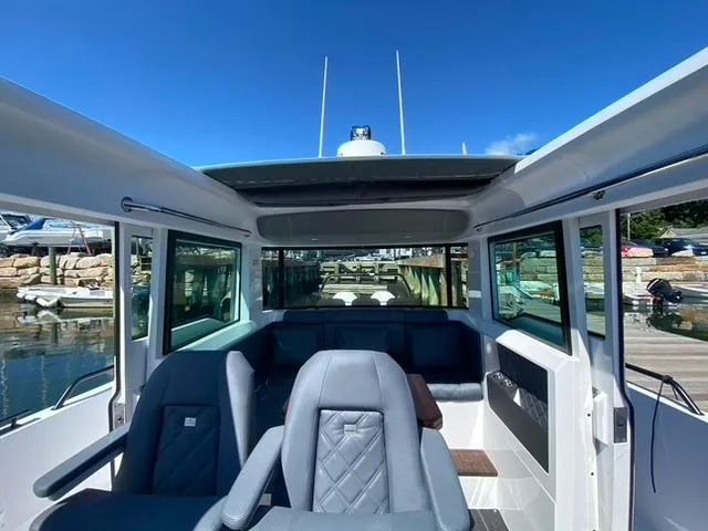 Slide: The Image of Interior of 2020 Axopar 37 XC boat with seating and panoramic windows. - 7