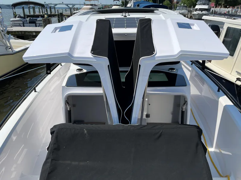 Slide: The Image of 2020 Axopar 37 XC boat with open deck and modern design at a marina. - 25