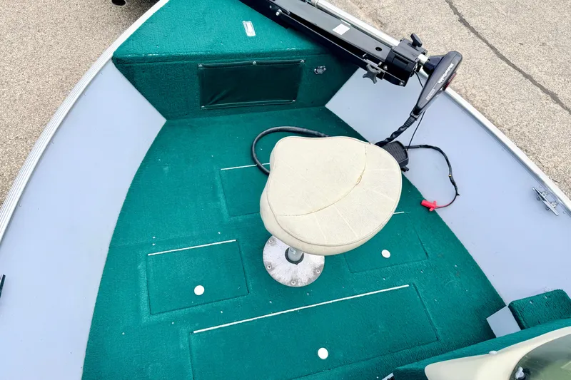 Slide: The Image of 2002 Lund 1650 Rebel SS boat interior with green carpet and swivel seat. - 37