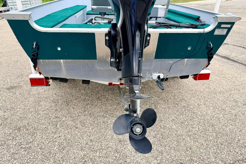 Slide: The Image of 2002 Lund 1650 Rebel SS boat rear view with motor and propeller. - 15
