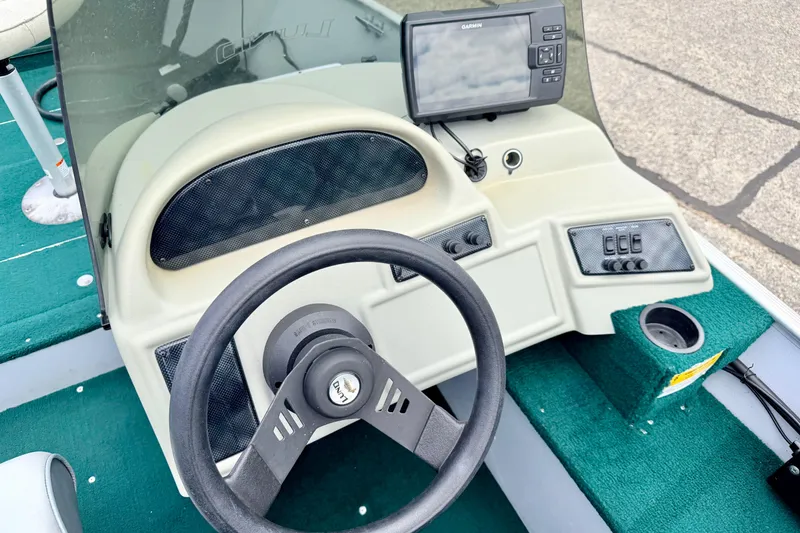 Slide: The Image of 2002 Lund 1650 Rebel SS boat dashboard with steering wheel and Garmin device. - 20
