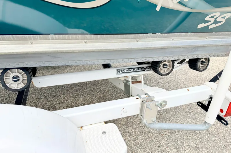 Slide: The Image of 2002 Lund 1650 Rebel SS boat trailer with EquiLoad rollers on pavement. - 63