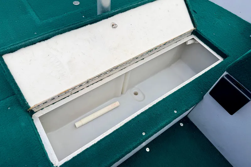 Slide: The Image of Open storage compartment in 2002 Lund 1650 Rebel SS boat with green carpet interior. - 40
