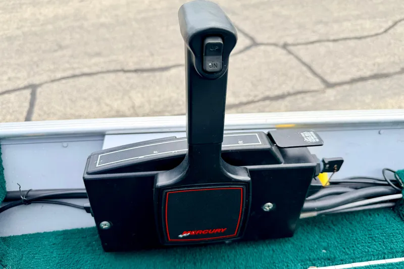 Slide: The Image of Mercury throttle control on 2002 Lund 1650 Rebel SS boat, featuring forward and reverse settings. - 24