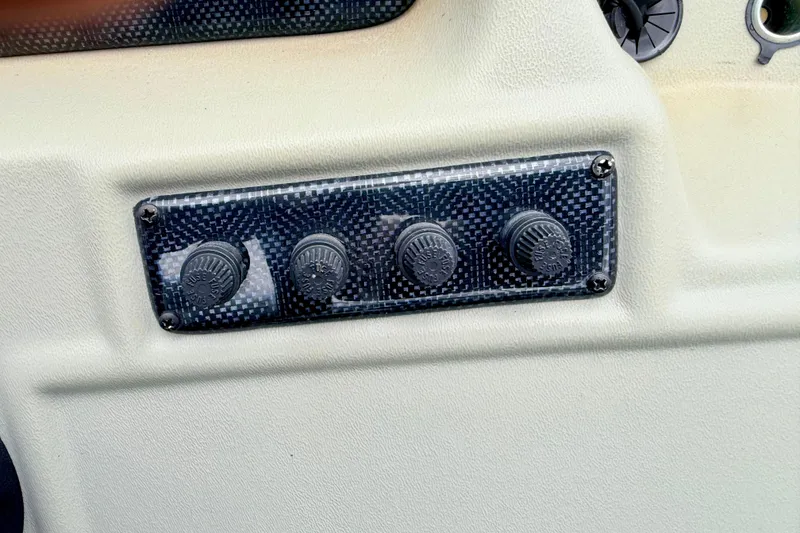 Slide: The Image of Control panel with four knobs on a 2002 Lund 1650 Rebel SS boat. - 22