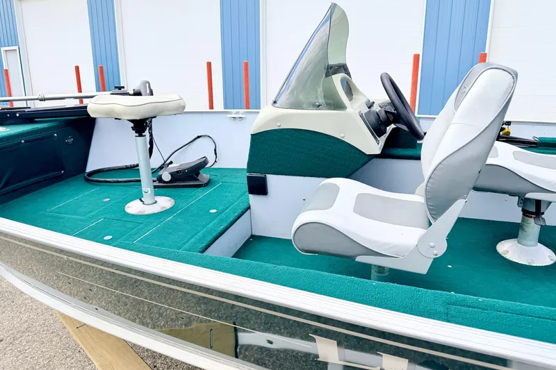 Slide: The Image of 2002 Lund 1650 Rebel SS boat interior with green carpet and white seats. - 58