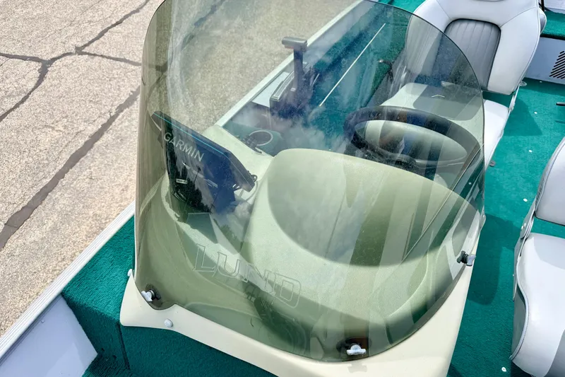 Slide: The Image of 2002 Lund 1650 Rebel SS boat cockpit with Garmin device and windshield. - 51