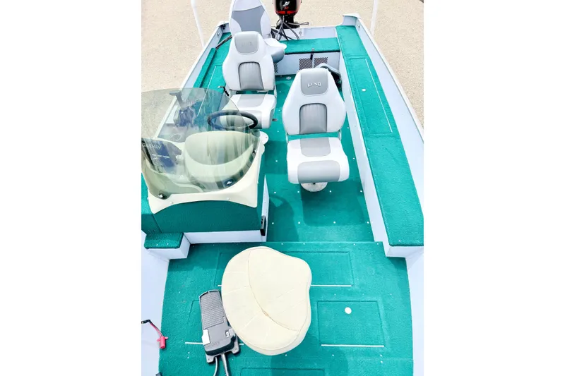 Slide: The Image of 2002 Lund 1650 Rebel SS boat interior with green carpet and seating arrangement. - 52