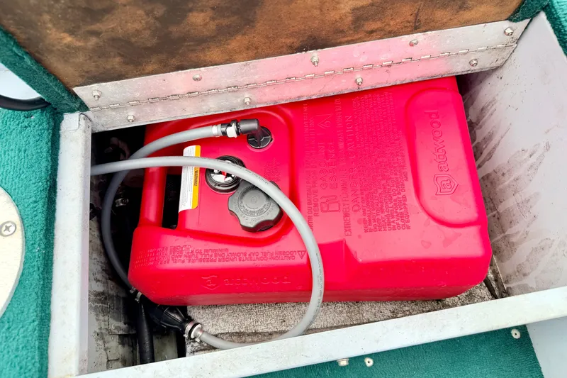 Slide: The Image of Red Attwood fuel tank in a 2002 Lund 1650 Rebel SS boat compartment. - 30