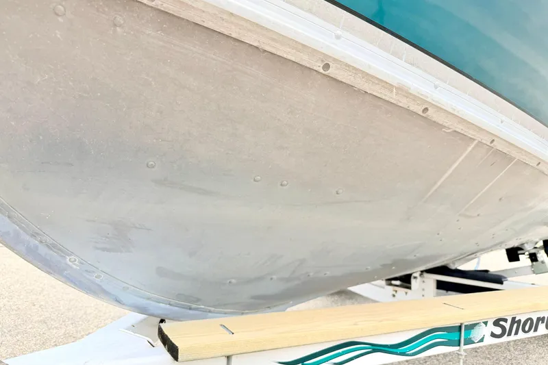 Slide: The Image of 2002 Lund 1650 Rebel SS boat hull on trailer, close-up view. - 60
