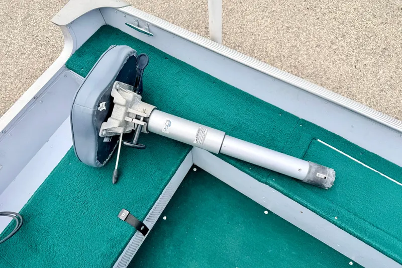 Slide: The Image of 2002 Lund 1650 Rebel SS boat interior with green carpet and seat pedestal. - 28