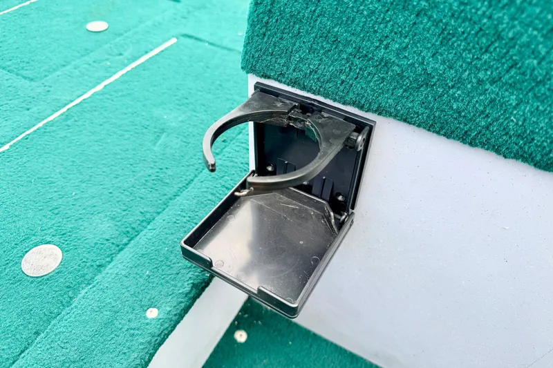 Slide: The Image of Foldable cup holder on 2002 Lund 1650 Rebel SS boat with green carpeted deck. - 38