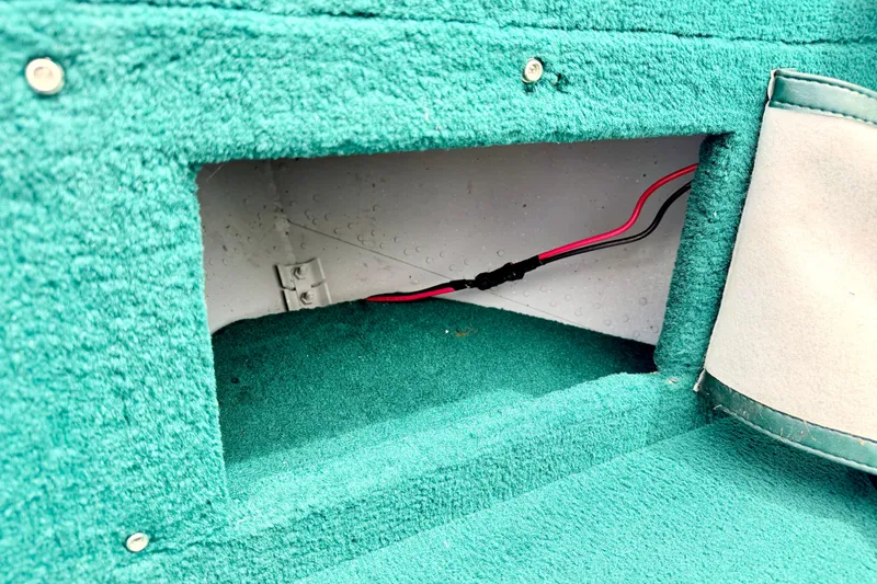 Slide: The Image of Interior compartment of a 2002 Lund 1650 Rebel SS boat with visible wiring. - 50