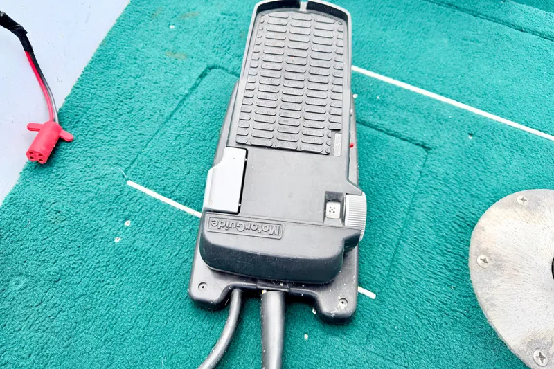 Slide: The Image of Foot pedal control on a 2002 Lund 1650 Rebel SS boat with green carpet. - 49