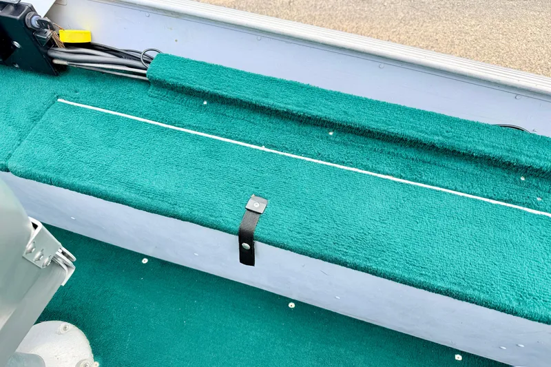 Slide: The Image of Interior of 2002 Lund 1650 Rebel SS boat with green carpeted seating. - 26