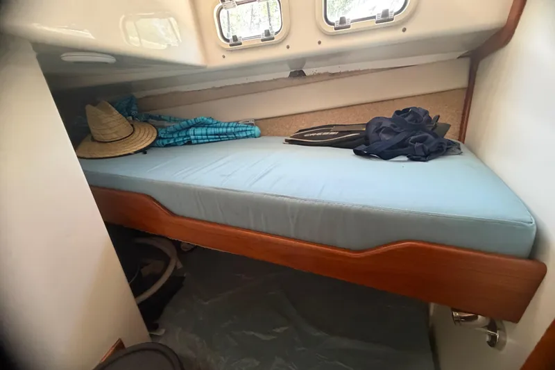 Slide: The Image of Cozy cabin interior of 2000 Cabo 35 Flybridge with bed and personal items. - 78