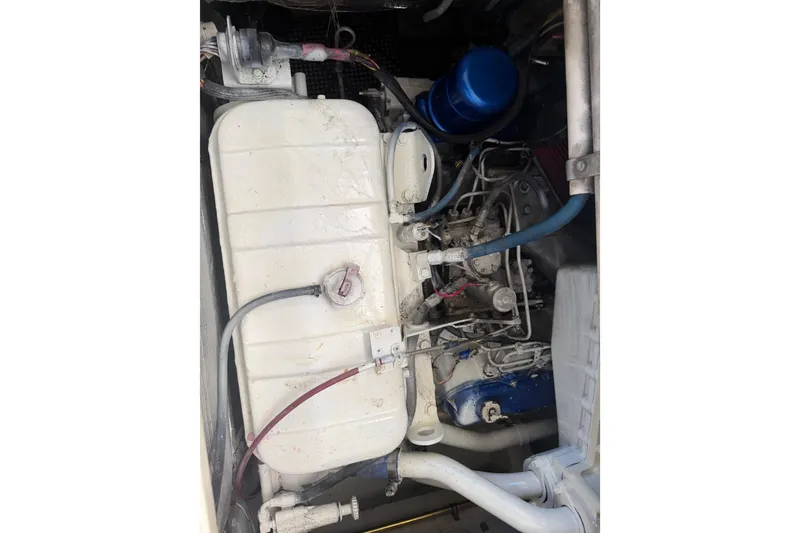 Slide: The Image of Engine compartment of a 2000 Cabo 35 Flybridge boat, showing mechanical components and wiring. - 106