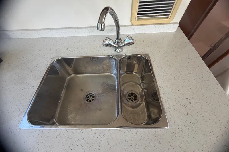 Slide: The Image of Stainless steel sink on Cabo 35 Flybridge 2000 boat with modern faucet. - 73