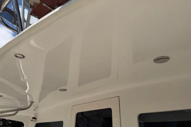 Slide: The Image of Cabo 35 Flybridge 2000 model, showcasing sleek white ceiling with recessed lighting. - 33