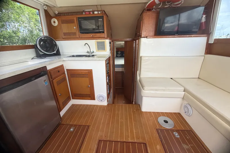 Slide: The Image of Interior of 2000 Cabo 35 Flybridge yacht with kitchenette and seating area. - 65