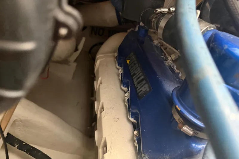 Slide: The Image of Engine compartment of a 2000 Cabo 35 Flybridge boat, featuring a Caterpillar engine. - 105