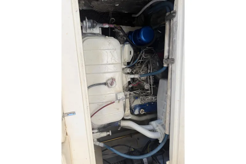 Slide: The Image of Engine compartment of a 2000 Cabo 35 Flybridge boat, showcasing mechanical components. - 102