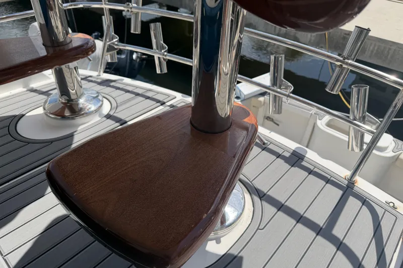 Slide: The Image of Cabo 35 Flybridge 2000 boat deck with polished wood and metal details. - 9