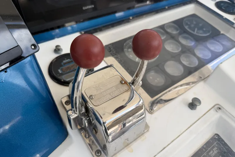 Slide: The Image of Close-up of Cabo 35 Flybridge 2000 boat controls with dual throttle levers. - 13