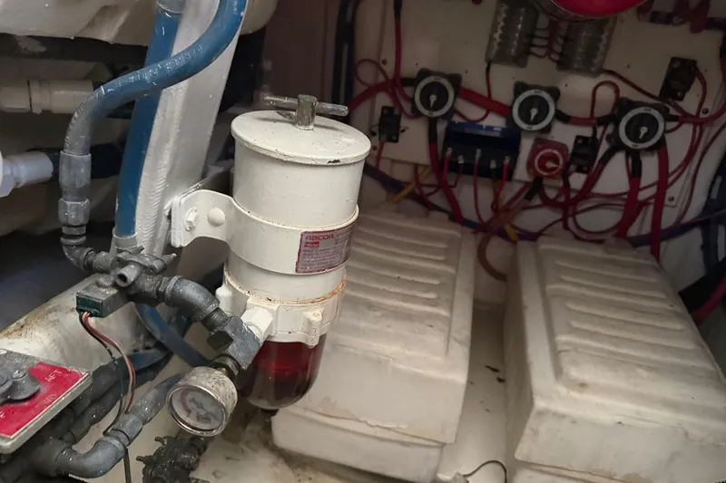 Slide: The Image of Engine room of a 2000 Cabo 35 Flybridge with fuel filter and wiring. - 93