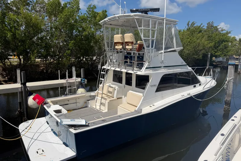 The Image of 2000 Cabo 35 Flybridge boat docked, featuring spacious deck and flybridge seating. - 0