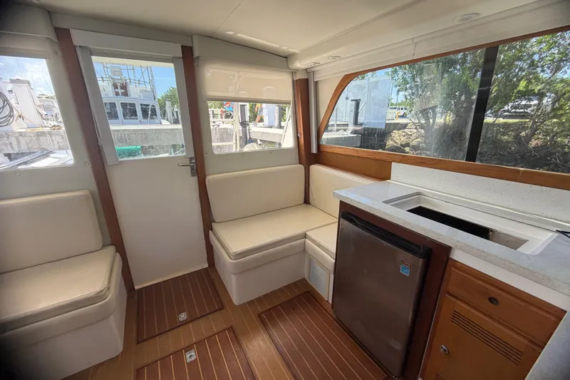 Slide: The Image of Interior of a 2000 Cabo 35 Flybridge boat with seating and kitchenette. - 60