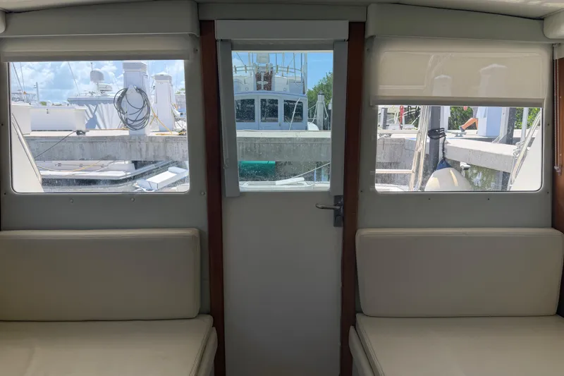 Slide: The Image of Interior view of a 2000 Cabo 35 Flybridge yacht with marina background. - 56