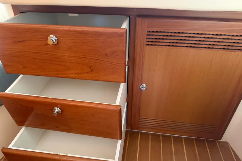 Slide: The Image of Wooden drawers and cabinet on a 2000 Cabo 35 Flybridge boat interior. - 89