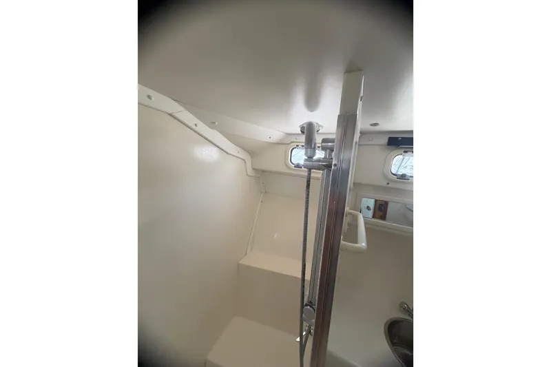 Slide: The Image of Interior of 2000 Cabo 35 Flybridge boat shower area with fixtures and porthole windows. - 87