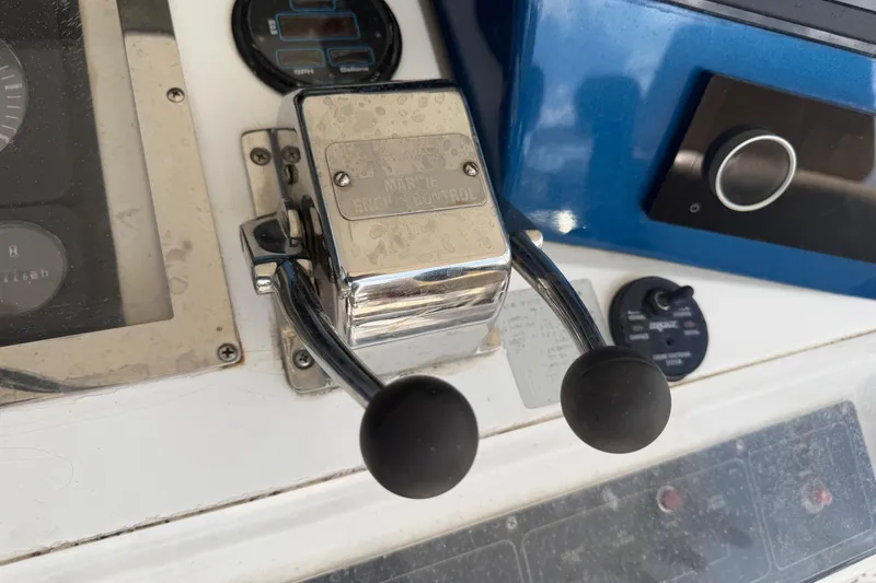 Slide: The Image of Close-up of Cabo 35 Flybridge 2000 boat throttle controls on dashboard. - 14