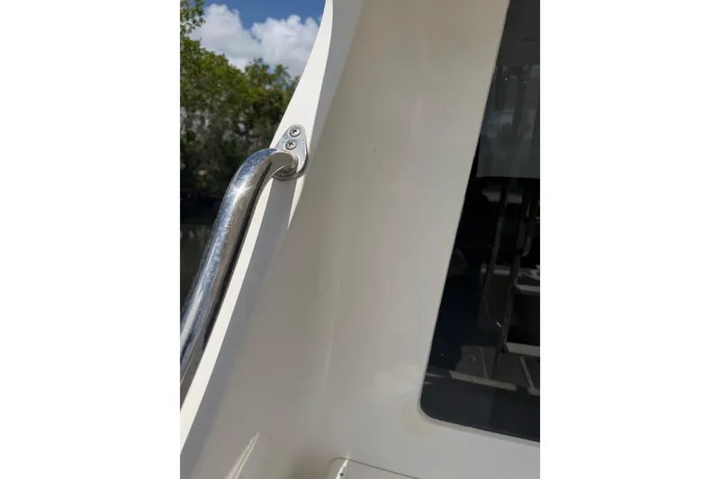 Slide: The Image of Close-up of a 2000 Cabo 35 Flybridge boat's railing and window. - 32