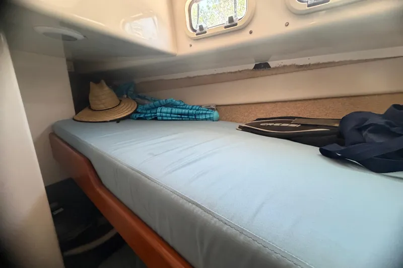 Slide: The Image of Cozy cabin interior of 2000 Cabo 35 Flybridge with bed, hat, and snorkeling gear. - 80