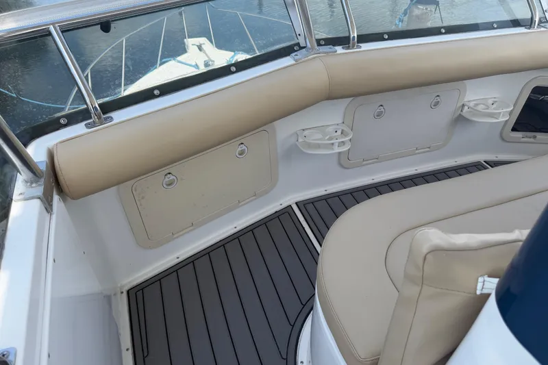 Slide: The Image of Cabo 35 Flybridge 2000 boat interior with beige seating and storage compartments. - 18