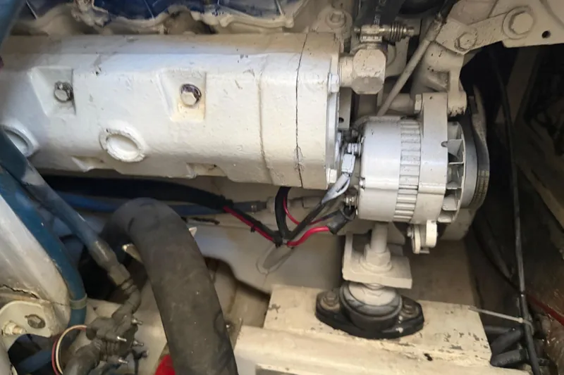Slide: The Image of Engine compartment of a 2000 Cabo 35 Flybridge boat, showing mechanical components. - 95