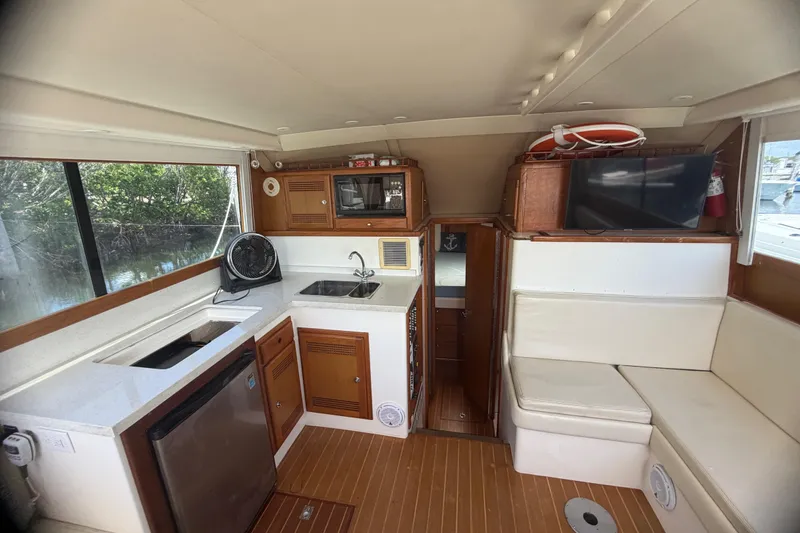 Slide: The Image of Interior of 2000 Cabo 35 Flybridge yacht with kitchenette and seating area. - 63