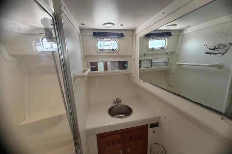 Slide: The Image of Bathroom interior of 2000 Cabo 35 Flybridge yacht with sink and mirror. - 85