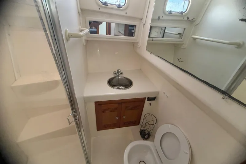 Slide: The Image of Bathroom interior of 2000 Cabo 35 Flybridge boat with sink, toilet, and mirror. - 86