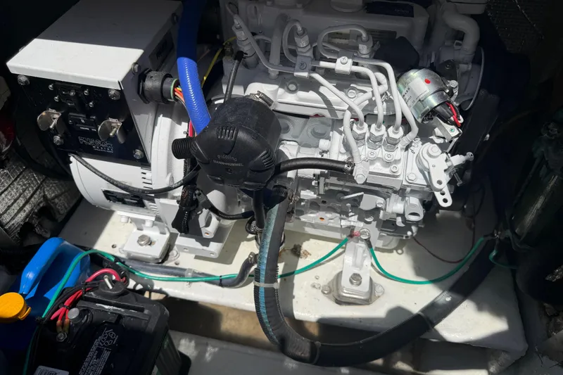 Slide: The Image of Engine compartment of a 2000 Cabo 35 Flybridge boat, showcasing mechanical components. - 92