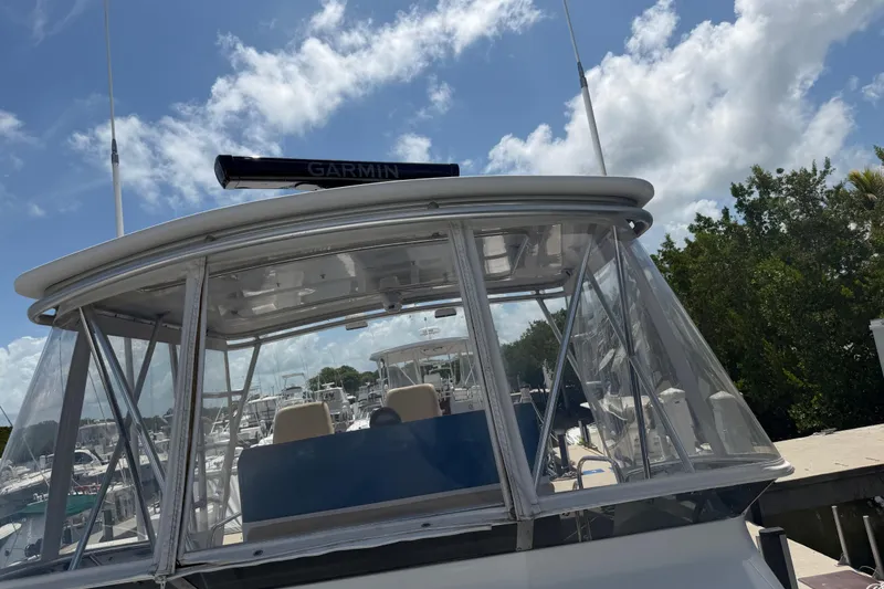 Slide: The Image of 2000 Cabo 35 Flybridge boat with Garmin equipment, docked under a partly cloudy sky. - 39