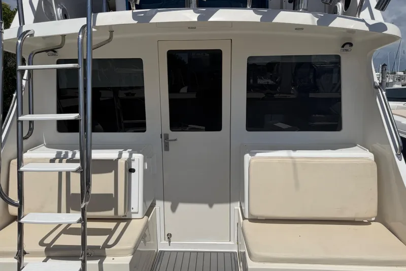 Slide: The Image of 2000 Cabo 35 Flybridge boat with ladder and seating on deck. - 50